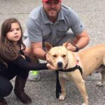 Lola in foster with two of her caretakers.